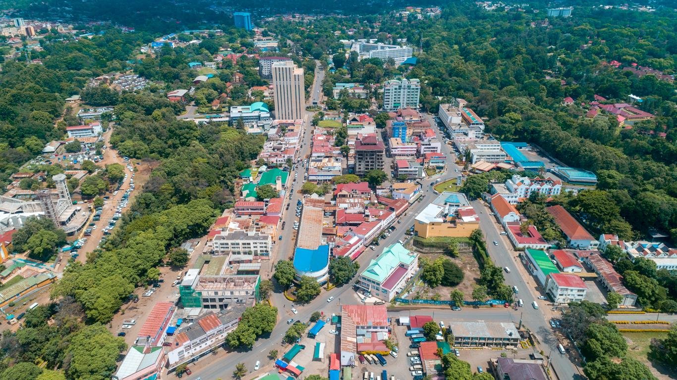 Arusha from the air, the town threaded through green hills at the foot of Mount Meru