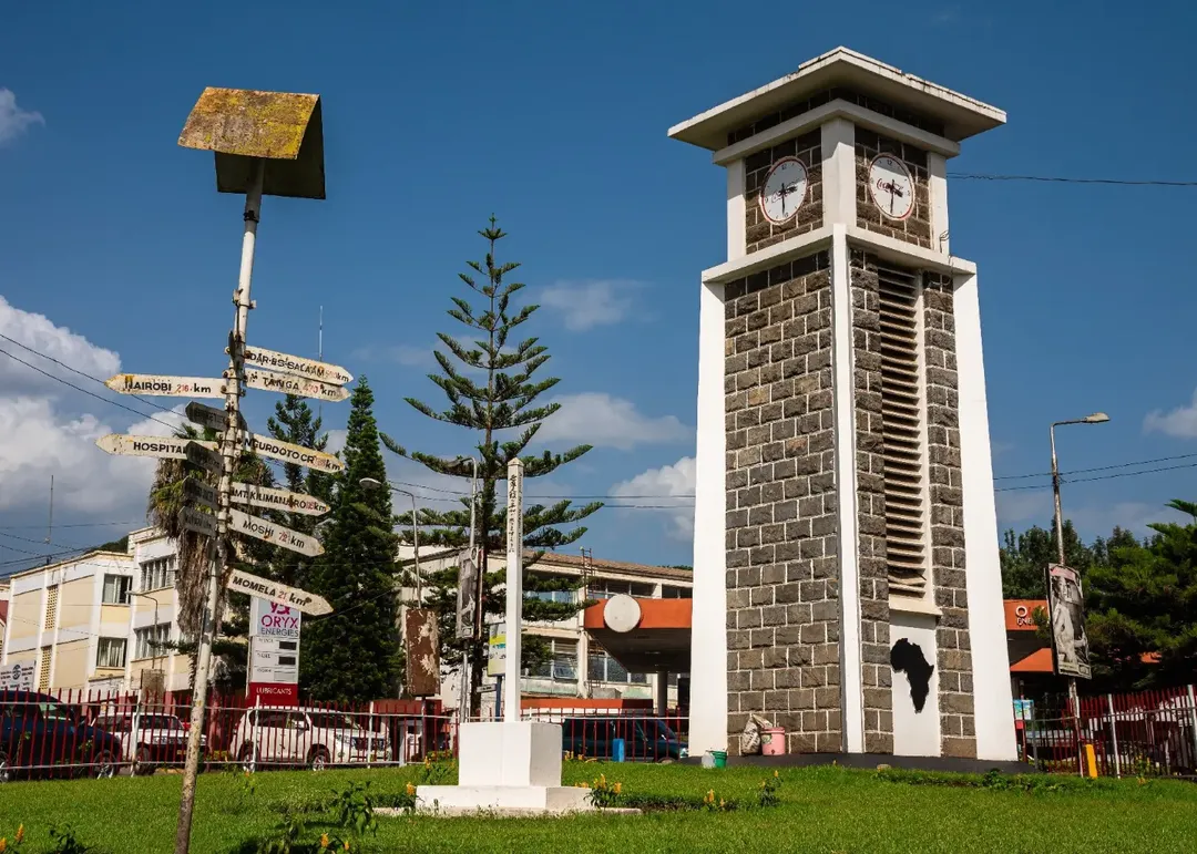 The Arusha clock tower and its signpost of distances, on the roundabout in the centre of town