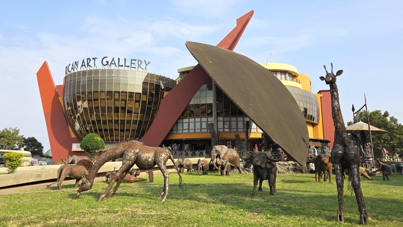 The Cultural Heritage centre outside Arusha, its red spear and gallery tower standing over a lawn of bronze giraffe and elephant