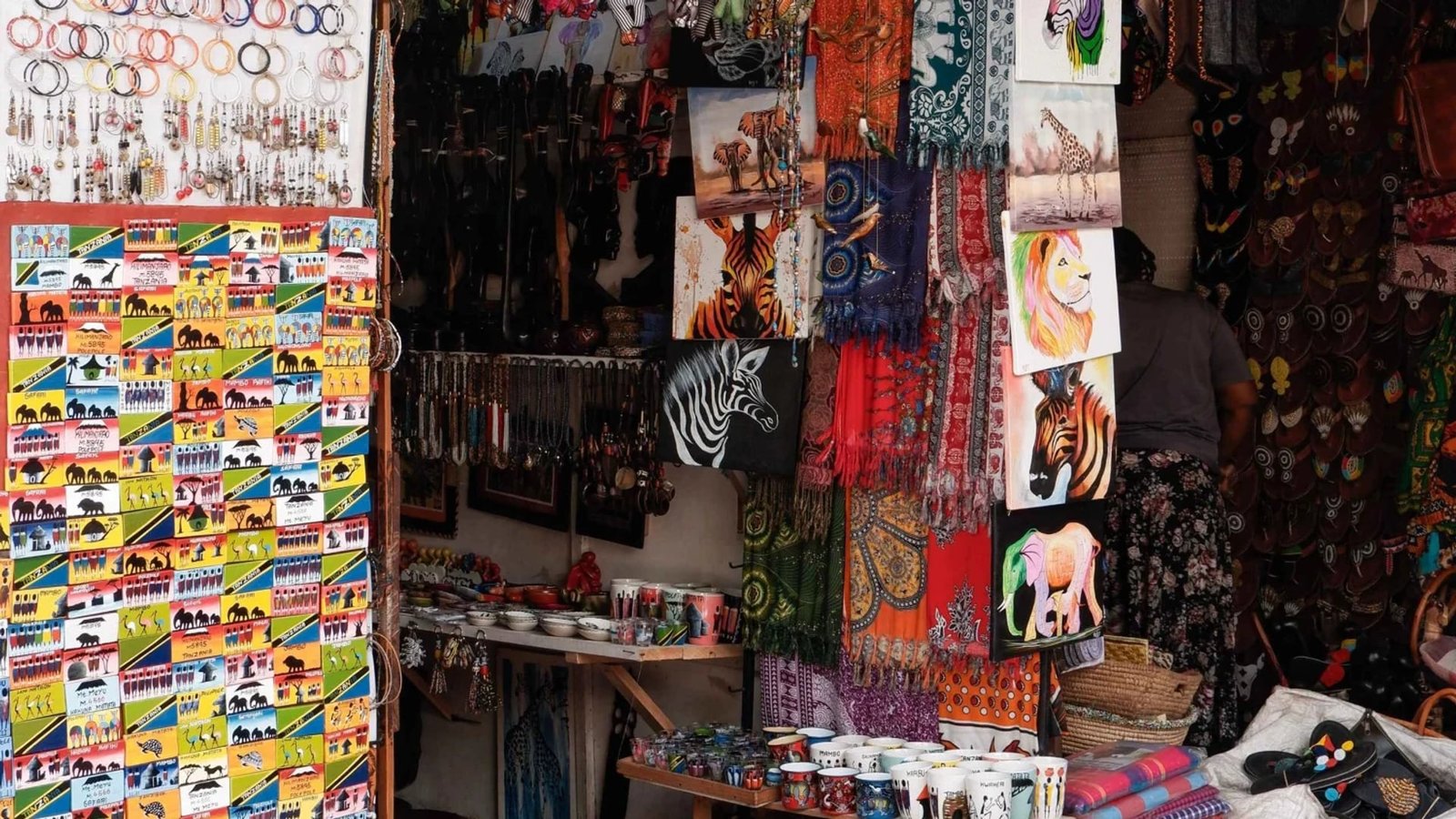 Paintings, fabrics and curios at an Arusha craft stall