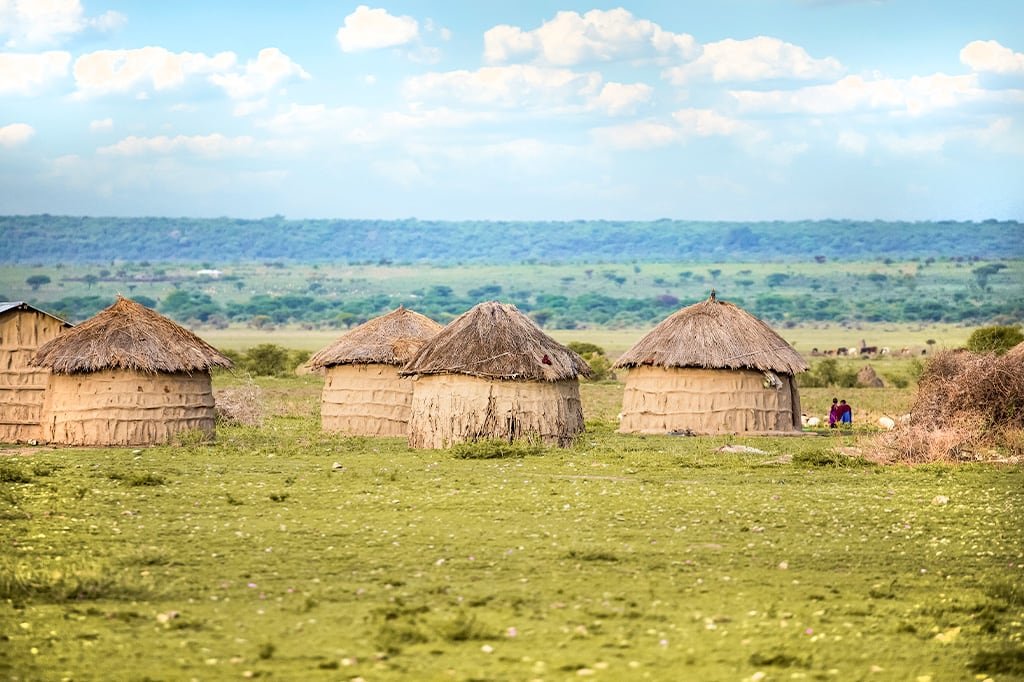 A Maasai boma of thatched huts on the open plain