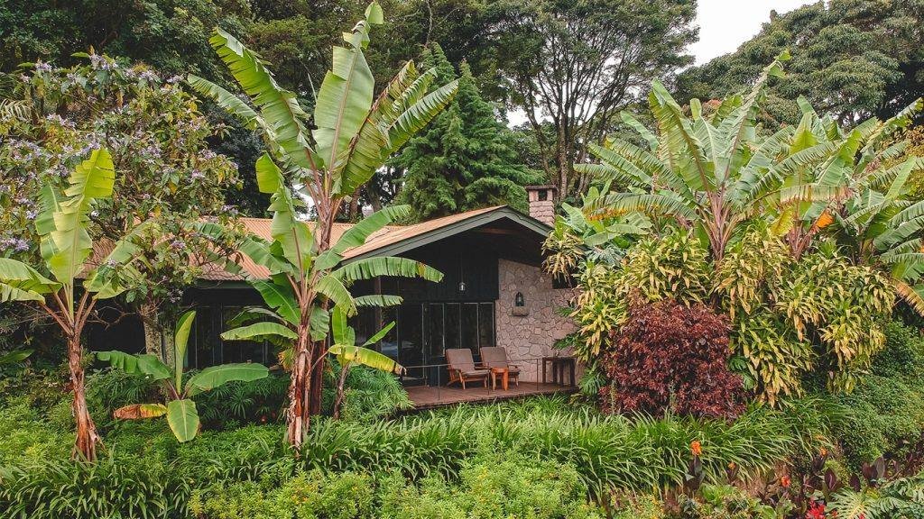 A stone farm cottage at Gibbs Farm surrounded by highland gardens